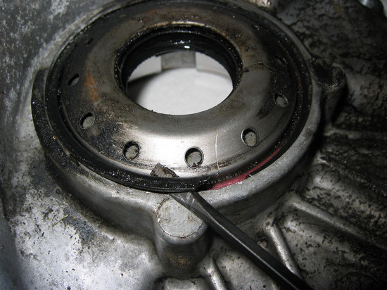 Axle seal retainer ring removal (outside case)